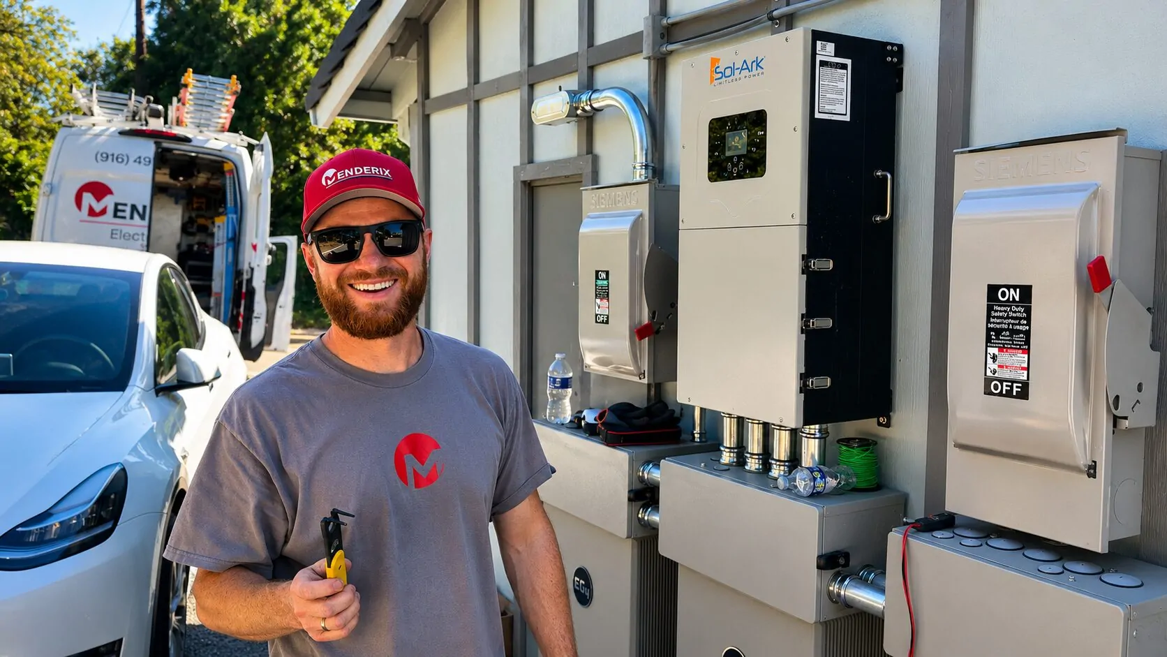 Menderix team member beside electrical equipment and a branded work vehicle